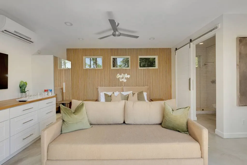 Bright vacation rental living room photographed from the doorway with the seating area centered
